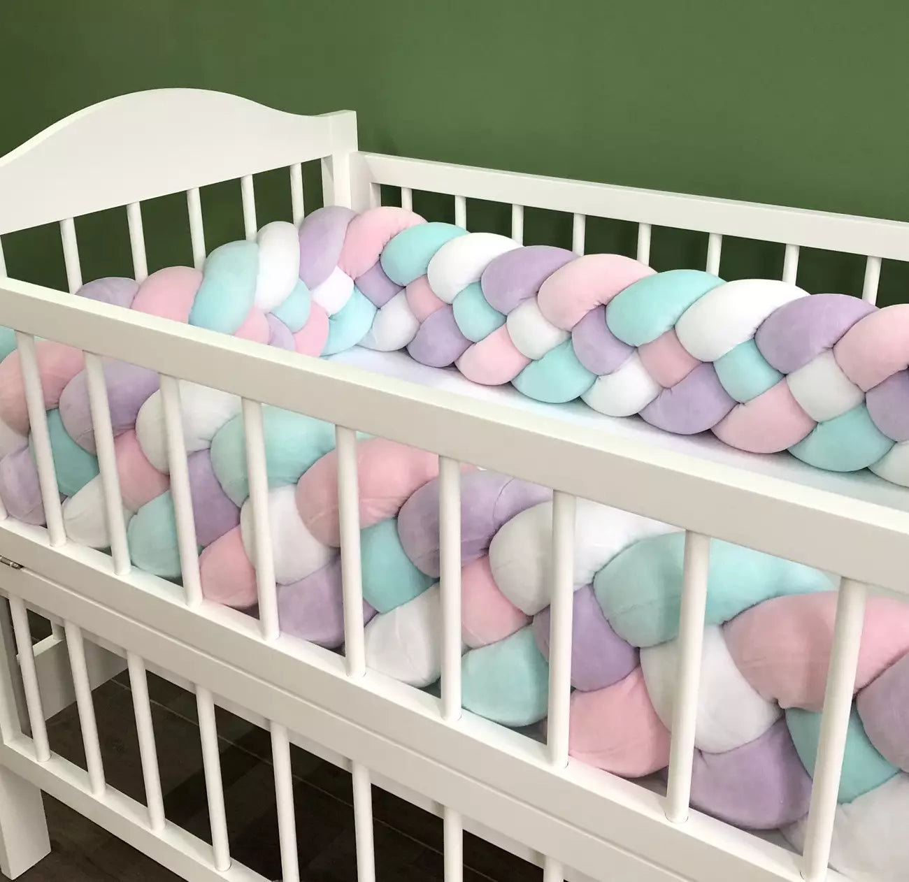 Braided bed bumpers in pink, lilac, white and cyan colors for crib